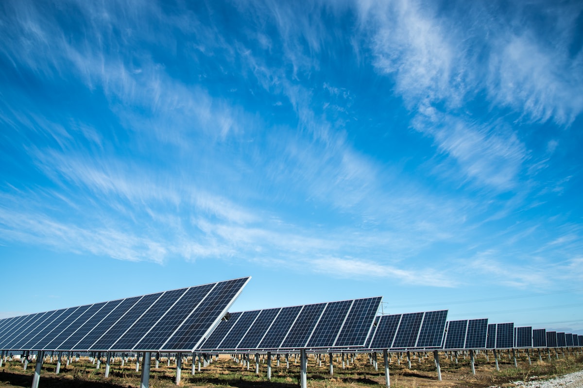 Solar panels producing clean energy beneath a bright sky